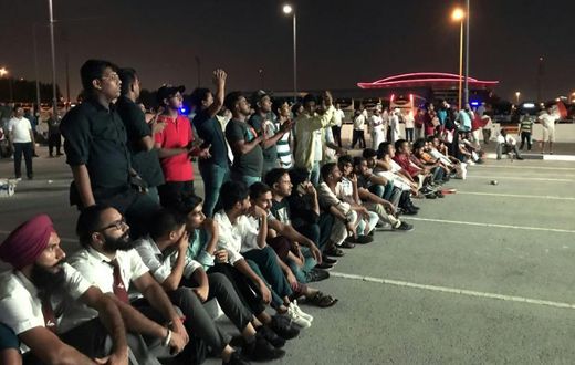 Indian fans who could not get tickets watch on a giant screen outside the stadium where Qatar play India in a World Cup tie