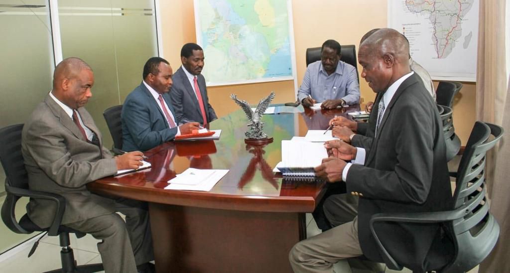 Trade CS Peter Munya receives advise from Raila Odinga during meeting at Capitol Hill