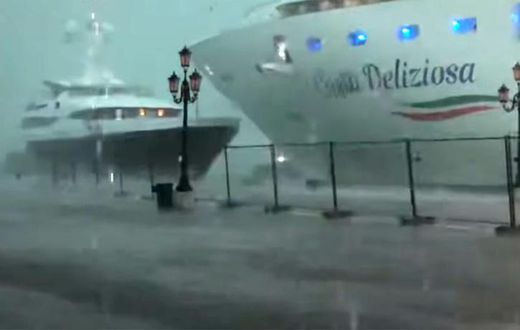 This photo grabbed from a video taken on July 7, 2019 and obtained on July 8, 2019 from Roberto Ferrucci (www.robertoferrucci.com) shows the 292-meter-long Costa Deliziosa cruise ship (right) close to a yacht (left) as it left Venice