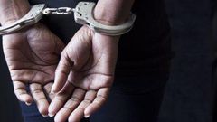 A woman handcuffed by police