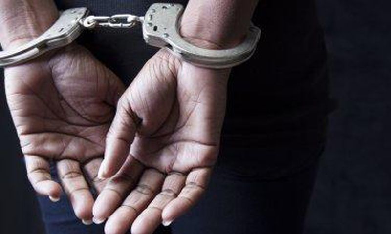 A woman .in handcuffs