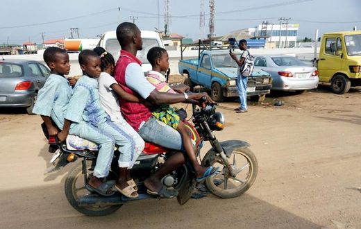 Room for one more? A traditional motorcycle taxi on Lagos roads -- overladen and not a crash helmet in sight