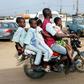 Room for one more? A traditional motorcycle taxi on Lagos roads -- overladen and not a crash helmet in sight