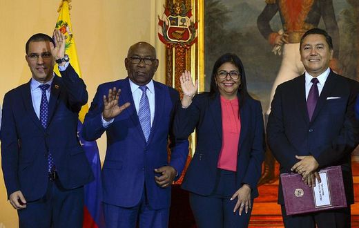 Venezuelan Foreign Minister Jorge Arreaza, Education Minister Aristobulo Isturiz, Vice President Delcy Rodriguez and opposition member Javier Bertucci pose after signing a dialogue agreement between the government and the opposition in Caracas