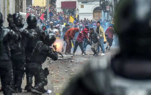 Demonstrators clash with riot police as thousands march against Ecuadorean President Lenin Moreno's decision to slash fuel subsidies, in Quito on October 9, 2019