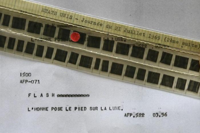 This 2019 photograph shows the AFP flash, stored in the agency's microfilmed archives, that announced that man had stepped on the Moon for the first time in July 1969