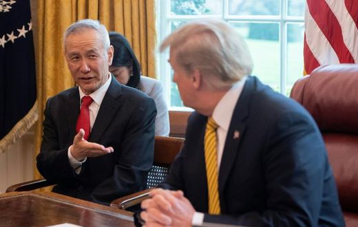 China's Vice Premier Liu He (L) speaks with US President Donald Trump during a trade meeting in the Oval Office at the White House in Washington in April 2019