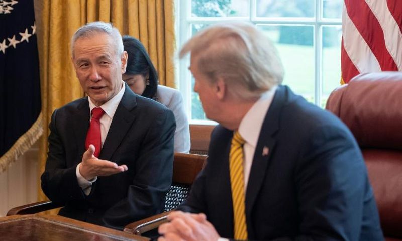 China's Vice Premier Liu He (L) speaks with US President Donald Trump during a trade meeting in the Oval Office at the White House in Washington in April 2019