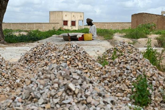 Sixteen people have died in an attack on a mosque in Burkina Faso's volatile north, security sources said; A woman, who is among the 300,000 internally displaced because of jihadist violence in northern and eastern Burkina Faso, is pictured September 1...