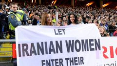 Supporters hold a banner calling for Iranian women to be allowed to enter football stadiums, during a match between Sweden and Iran in Solna near Stockholm in March 2015