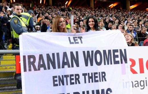 Supporters hold a banner calling for Iranian women to be allowed to enter football stadiums, during a match between Sweden and Iran in Solna near Stockholm in March 2015