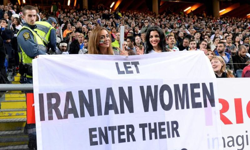 Supporters hold a banner calling for Iranian women to be allowed to enter football stadiums, during a match between Sweden and Iran in Solna near Stockholm in March 2015