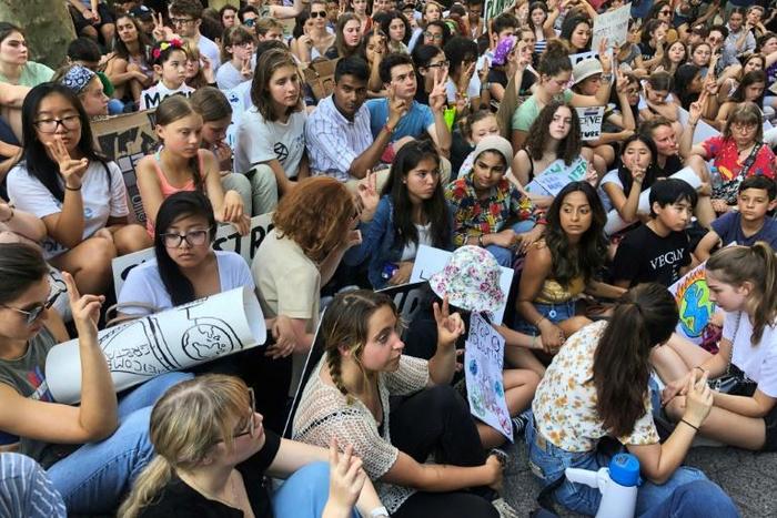 Great Thunberg (2nd L in pink) joins a protest by climate activist near the UN headquarters on August 30, 2019, in New York.