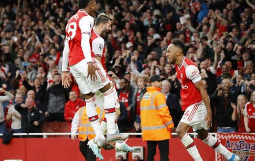 Top Gunner: Pierre-Emerick Aubameyang (right) celebrates scoring the winner in a thrilling 3-2 victory over Aston Villa