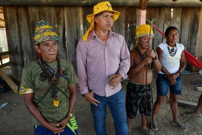 Brazilian illegal gold miner Inacio Vilela (2-L) and Munduruku indigenous people, speak with AFP in Morais Almeida, Itaituba, Para state, Brazil, on September 13, 2019. Members of an indigenous tribe have called for wildcat miners to be allowed to pros...