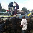 Members of the public assist passengers on 14-seater matatu that overturned at Ngara along Murang'a Road
