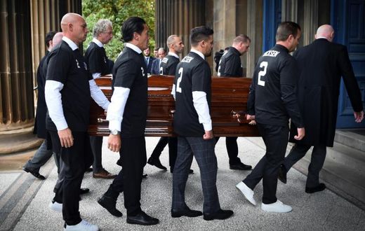 Pallbearers wore number 2 shirts with the name of Fernando Ricksen at his funeral in Glasgow on Wednesday