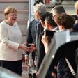 Germany's Chancellor Angela Merkel (L) is greeted by well-wishers upon her arrival in Japan for the G20 summit as officials sought to play down fears over her health