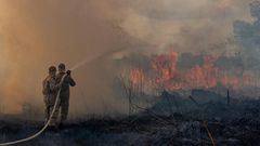 Firefighters in the Brazilian Amazon basin state of Mato Grosso battle a forest blaze in the municipality of Sorriso