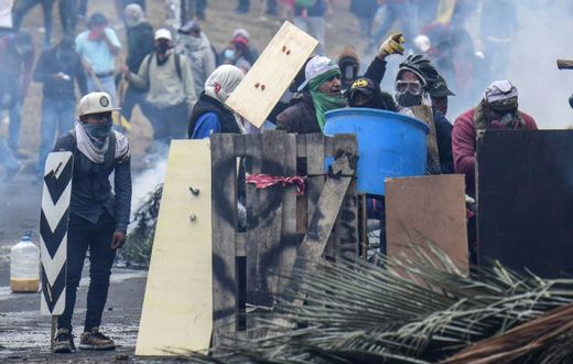 Demonstrators in Ecuador clash with riot police during a protest over a fuel price hike ordered by the government to secure an IMF loan