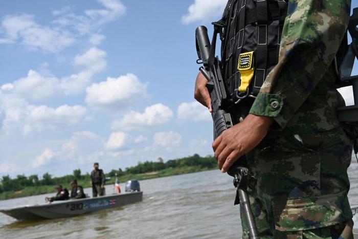 An armed Thai navy personnel patrols along the Mekong river in Nakhon Phanom province, where drug gangs ship meth from Laos to Thailand
