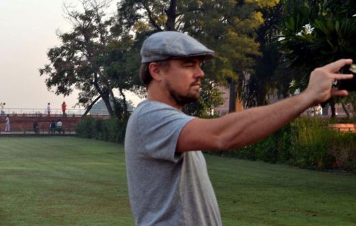 Hollywood star Leonardo DiCaprio takes a photograph in the gardens of the Taj Mahal during a visit to India in 2015