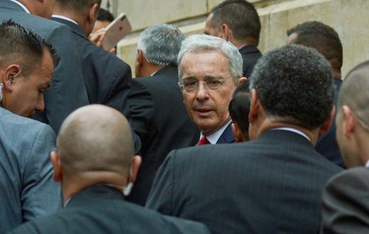 Former Colombian president Alvaro Uribe (C) arrives at the Palace of Justice for a hearing before the Supreme Court in a case over witness tampering