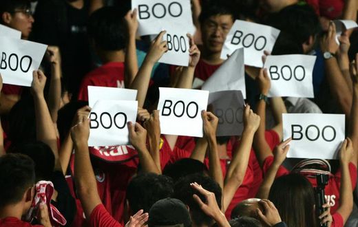 Hong Kong's football body has been fined after fans turned their backs and booed during the Chinese anthem at the start of a World Cup qualifying football match against Iran