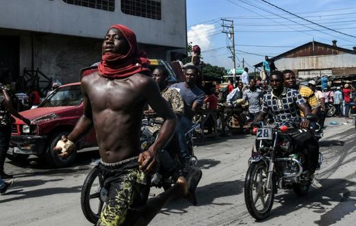 (FILES) In this file photo taken on September 23, 2019 demonstrators march on the street near parliament as they protest against ruling government in Port-au-Prince. The UN has called for calm in crisis-wracked Haiti, eight days before the end of its p...