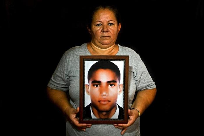 Luz Edilia Florez, 57, mother of disappeared Jose Ernesto Moran, poses with a photo of him in Cali, Colombia