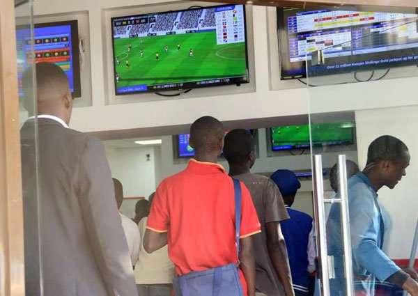 Kenyans place their bets at a betting facility. Association of Gaming Operators explains how 20% withholding tax is calculated on winnings