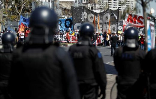 Riot police face off against demonstrators in Buenos Aires, during a protest against the economic policies Argentine President Mauricio Macri. Argentina will hold presidential elections next October 27.