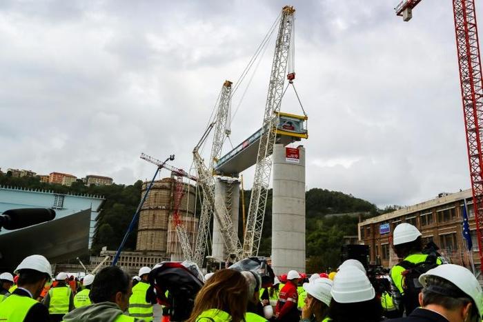 The first deck of Genoa's new bridge was lifted into position just over a year after the collapse that killed 43 people