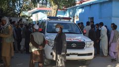 Afghans wait outside a hospital in Kabul for news of friends and family injured in a Taliban attack