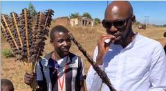 Larry Madowo eating Mouse