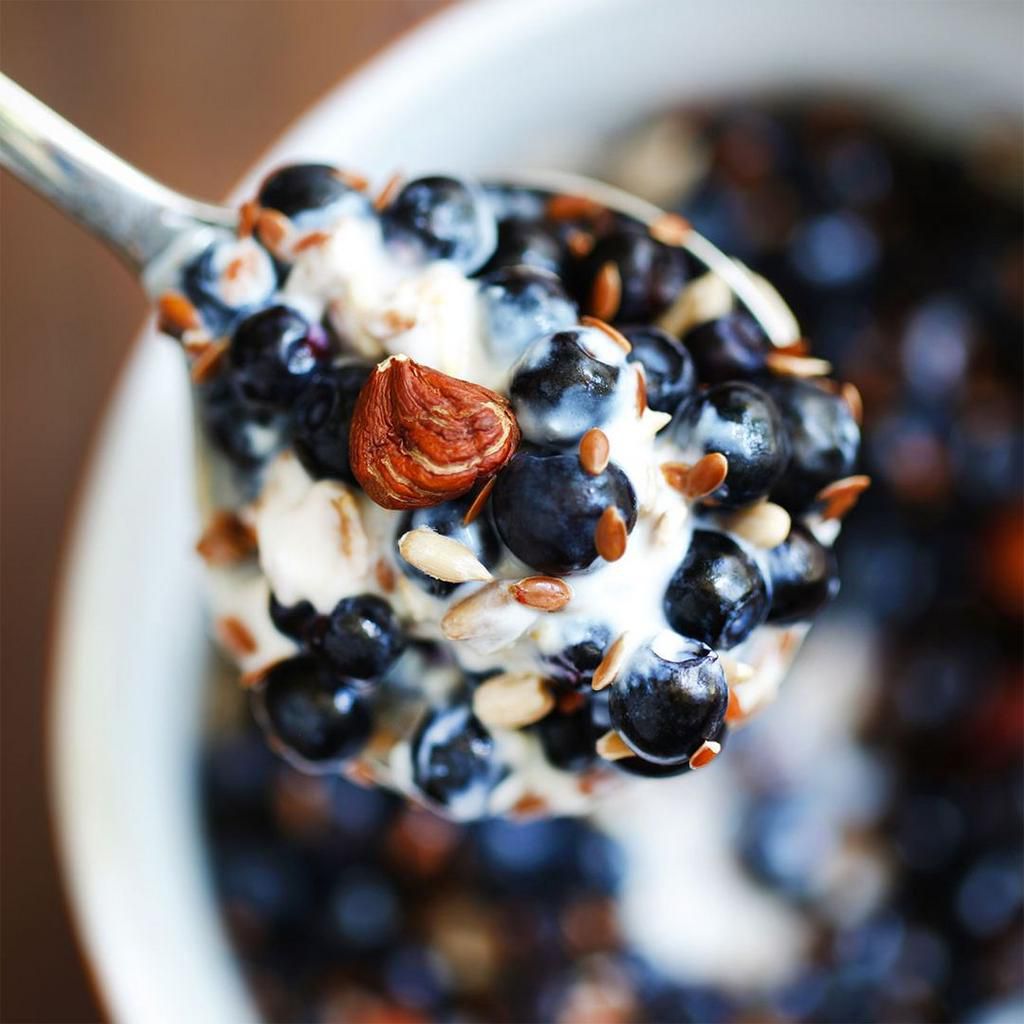 nuts and seeds and berries mixed with yogurt