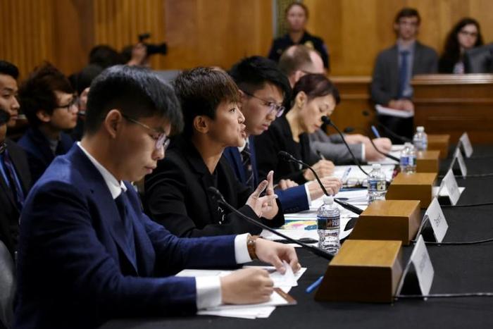 Prominent activist Joshua Wong (L) and Cantopop star Denise Ho (C) testified before a congressional commission about the pro-democracy movement in Hong Kong