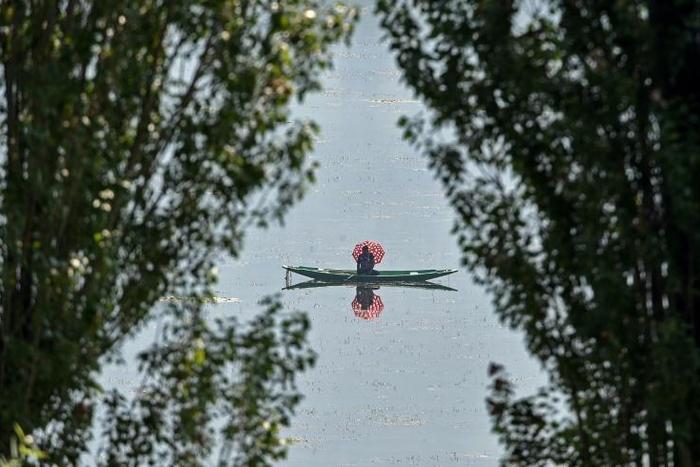 A man fishes on Dal Lake in Srinagar. Usually a thriving tourist destination, the region has been hard hit by the latest political crisis