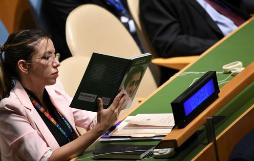 A Venezuelan delegate holds up a book referring to South American independence hero Simon Bolivar while US President Donald Trump addresses the UN General Assembly