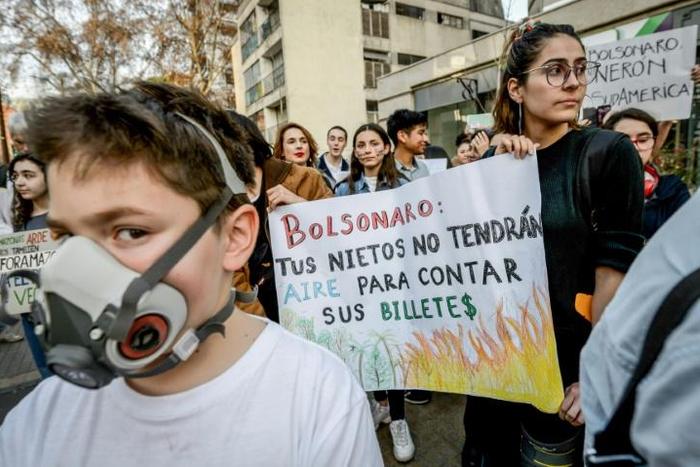 Marchers protest against Brazilian President Jair Bolsonaro over the fires in the Amazon rainforest in front of Brazil's embassy in Santiago, Chile August 23, 2019