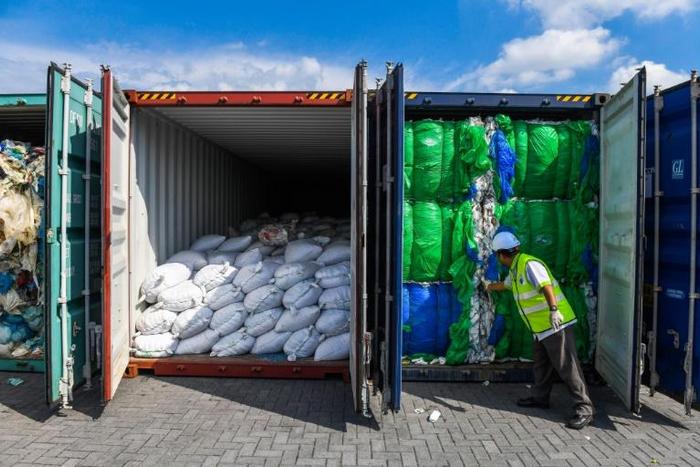 A Malaysian official inspects containers filled with plastic waste in Port Klang, west of Kuala Lumpur, in May 2019