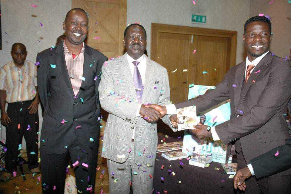 Kibe during his time as the CEO of Flamekeepers Publishing with Raila Odinga and Allan Wanga (Courtesy)