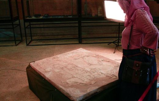 A visitor looks at a wall relief inscription, discovered at the temple of Soleb, on display at the Sudan National Museum on Thursday
