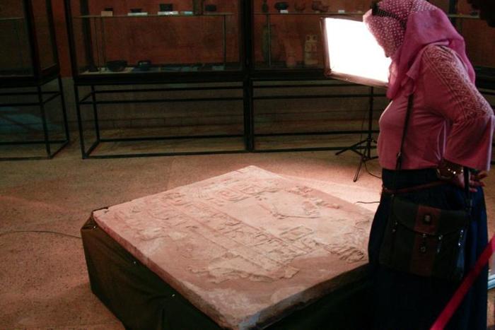A visitor looks at a wall relief inscription, discovered at the temple of Soleb, on display at the Sudan National Museum on Thursday