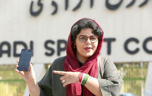 Iranian sports journalist Raha Pourbakhsh shows purchased electronic tickets for the Iran-Cambodia World Cup 2022 match in front of Azadi stadium in the capital Tehran