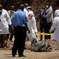 Detectives stabd next to the body of murdered Catholic priest Michael Kyengo