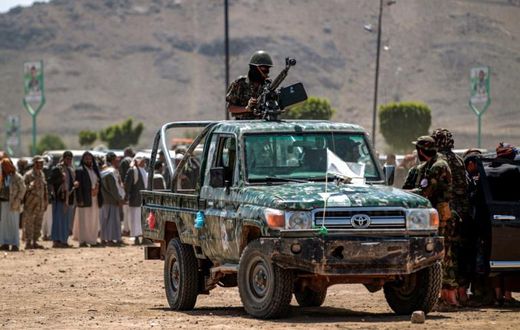 A fighter loyal to Yemen's Huthi rebels mans a machine gun turret during a tribal meeting in the Huthi-held capital Sanaa on September 21
