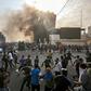 Protesters clash with an Iraqi riot police during a demonstration against state corruption and poor services in Baghdad