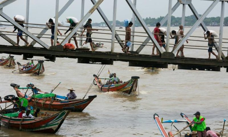 People from Dala township arrive in Yangon by boat after crossing the river