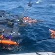 A photo released by the Colombian Navy on October 1, 2019 shows the rescue of three men floating on bales of cocaine off the Pacific coast
